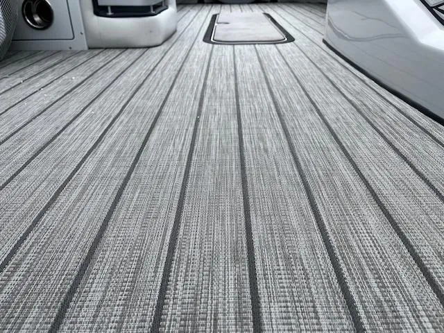 Slide: The Image of 2025 Harris Grand Mariner 250 boat deck with sleek, modern design and textured flooring. - 19