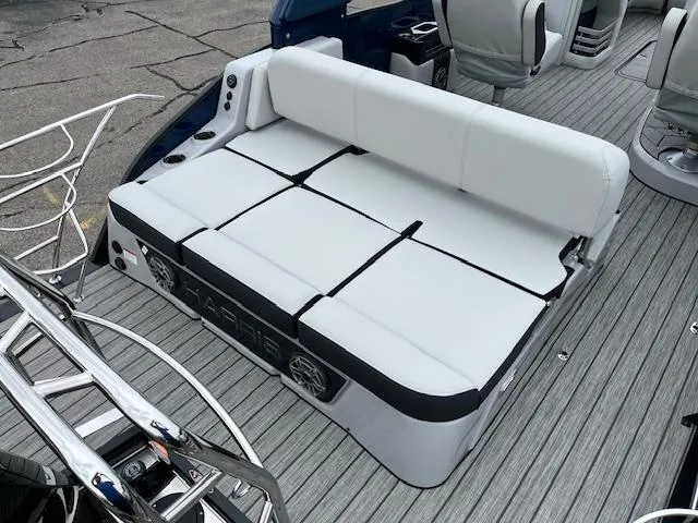 Slide: The Image of 2025 Harris Grand Mariner 250 boat interior with white seating and modern design. - 8