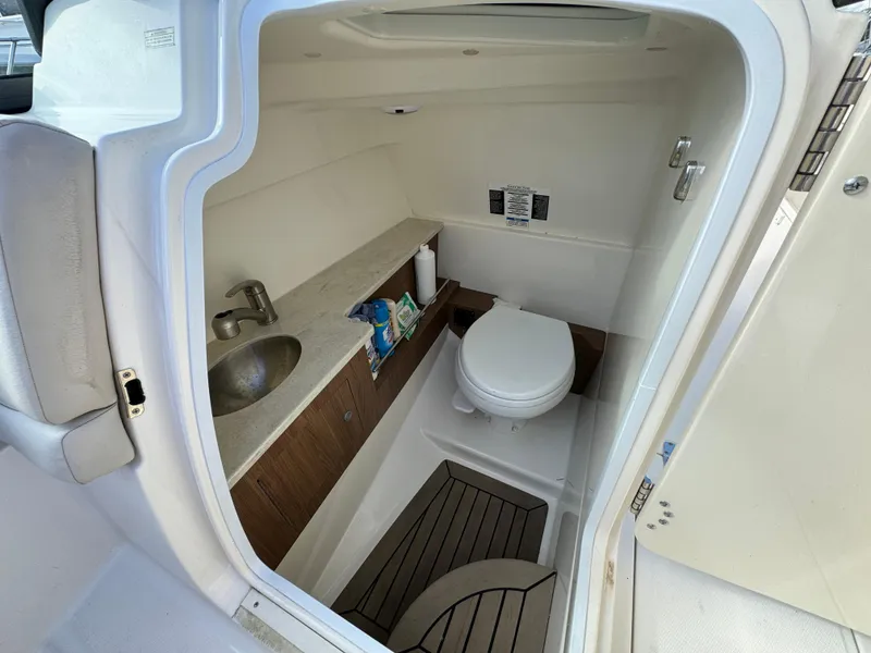 Slide: The Image of Interior of 2013 Boston Whaler 270 Vantage boat bathroom with sink and toilet. - 15