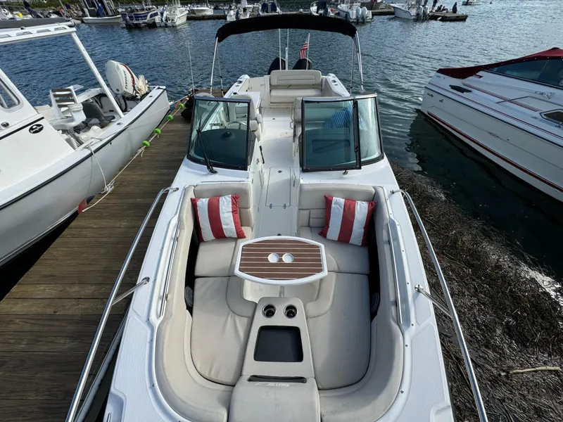 Slide: The Image of 2013 Boston Whaler 270 Vantage boat docked, featuring spacious seating and elegant design. - 18