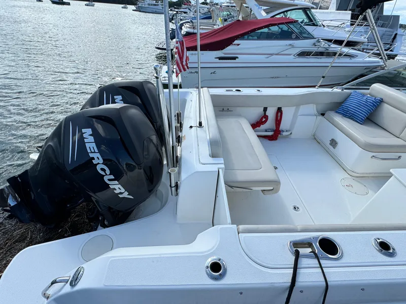 Slide: The Image of 2013 Boston Whaler 270 Vantage boat with Mercury engines docked by the water. - 4