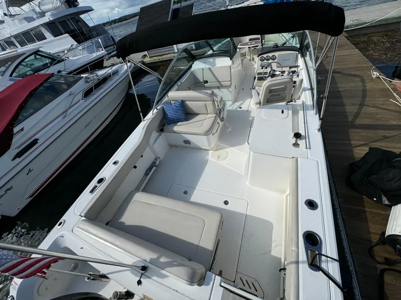 Slide: The Image of 2013 Boston Whaler 270 Vantage boat docked, featuring spacious seating and sleek design. - 5