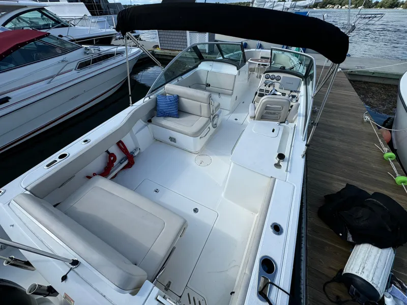 Slide: The Image of 2013 Boston Whaler 270 Vantage boat with spacious seating and modern design at dock. - 6