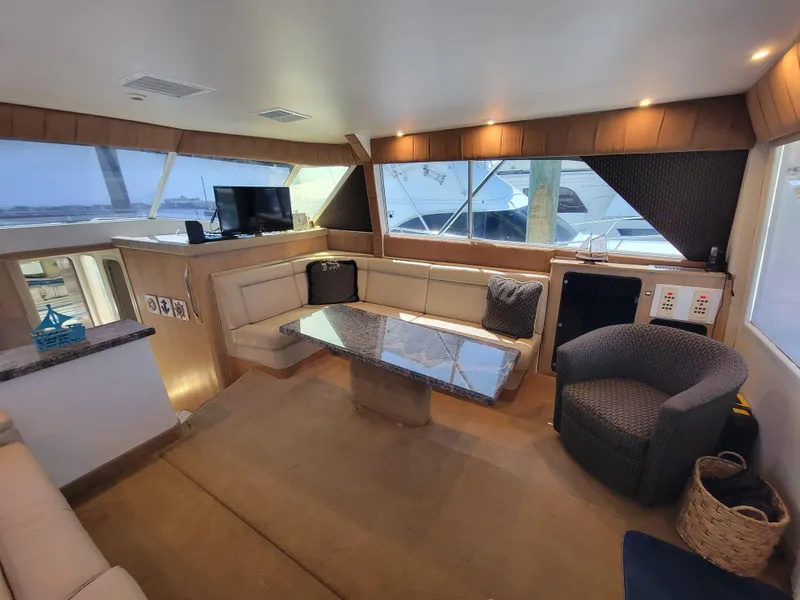 Slide: The Image of Luxurious interior of 1989 Trojan 46 Sportfish yacht with modern seating and entertainment area. - 10