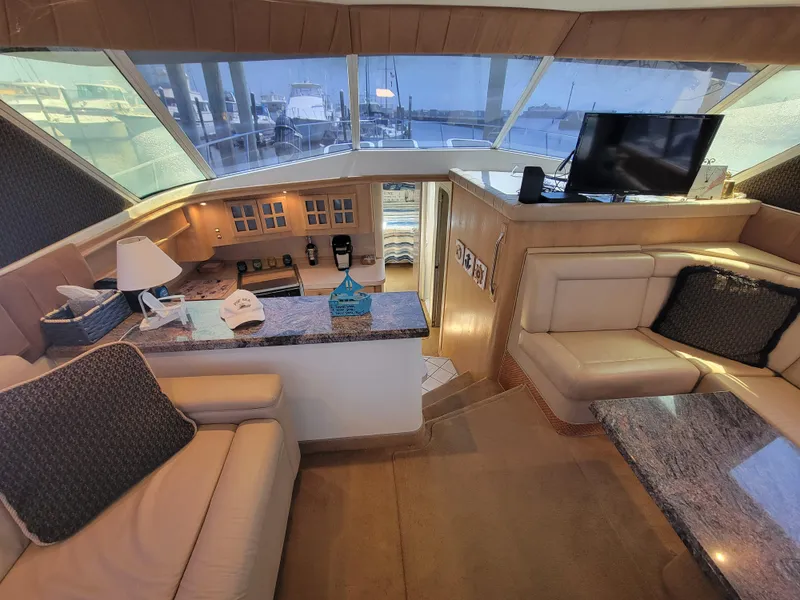 Slide: The Image of Luxurious interior of a 1989 Trojan 46 Sportfish yacht with plush seating and modern amenities. - 13