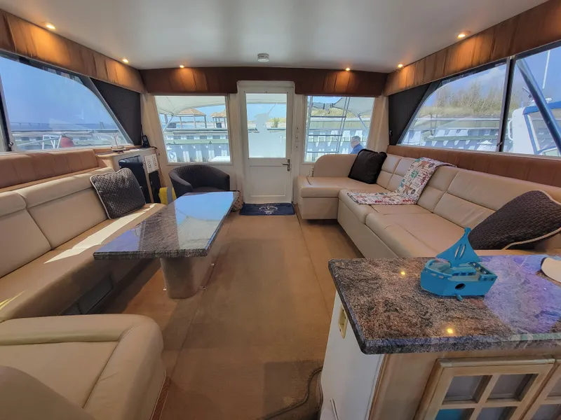 Slide: The Image of Luxurious interior of 1989 Trojan 46 Sportfish yacht with plush seating and elegant decor. - 16