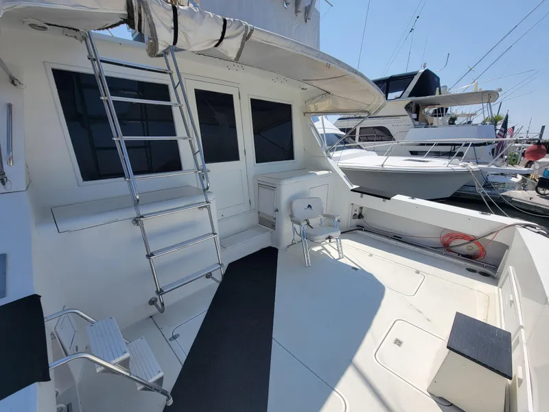Slide: The Image of 1989 Trojan 46 Sportfish boat deck with ladder and seating area. - 9