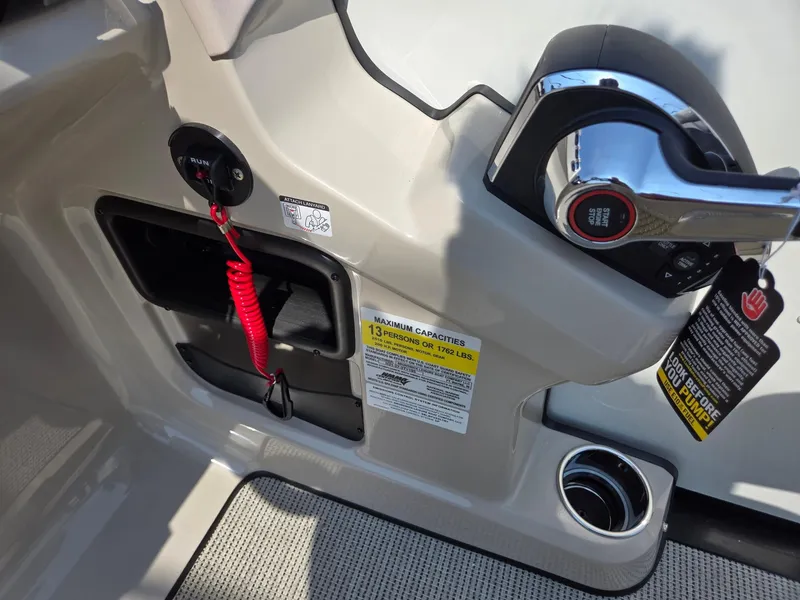 Slide: The Image of 2025 Harris Cruiser 210 boat control panel with safety features and capacity label. - 15