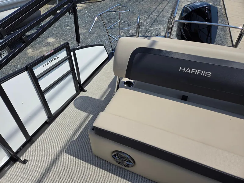 Slide: The Image of 2025 Harris Cruiser 210 boat interior with beige seating and branded details. - 17