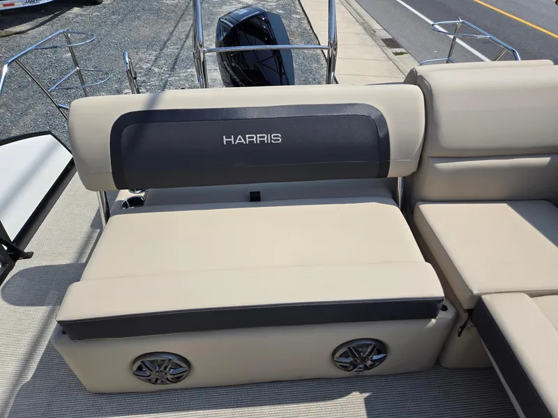 Slide: The Image of 2025 Harris Cruiser 210 boat interior with beige seating and built-in speakers. - 18
