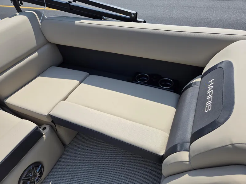 Slide: The Image of 2025 Harris Cruiser 210 boat interior with beige seating and cup holders. - 19