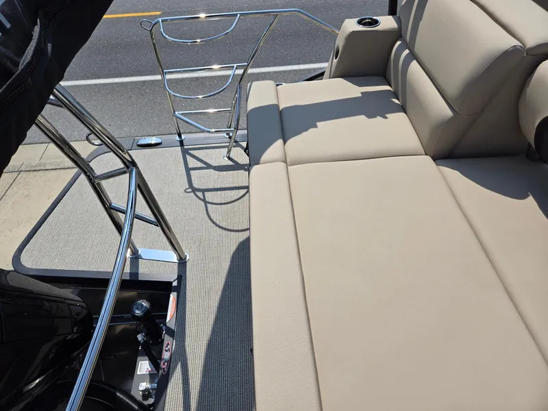 Slide: The Image of 2025 Harris Cruiser 210 boat interior with beige seating and metal railings. - 22