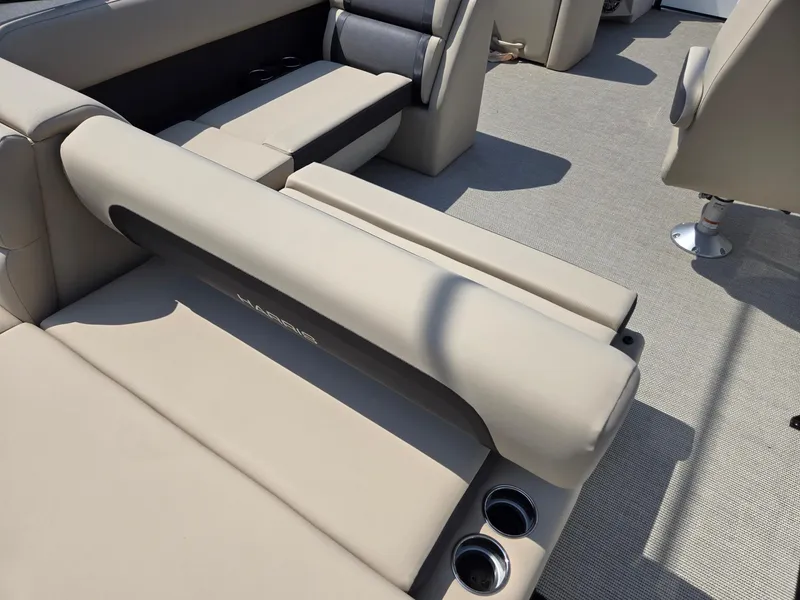 Slide: The Image of 2025 Harris Cruiser 210 interior with beige seating and cup holders. - 23