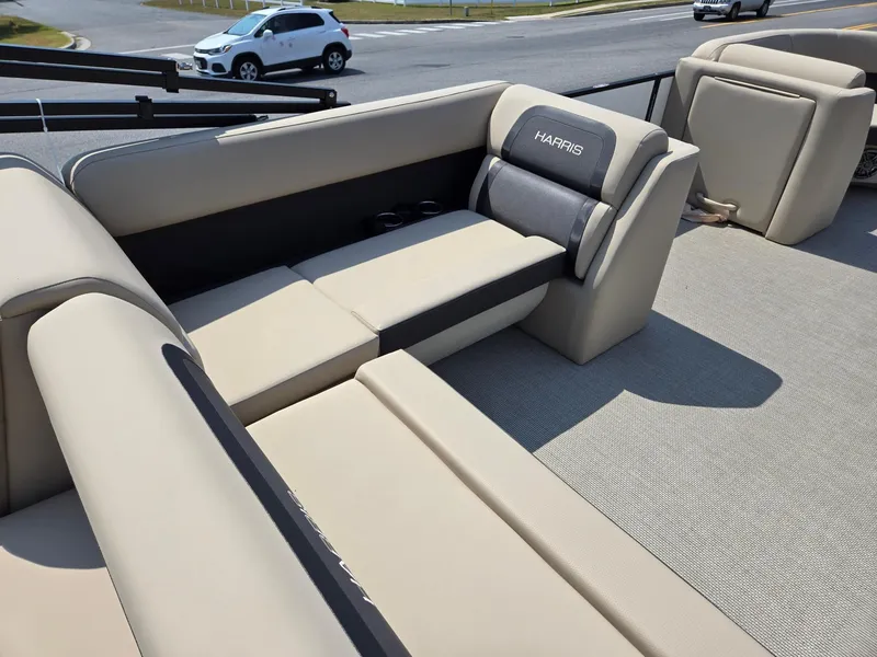 Slide: The Image of 2025 Harris Cruiser 210 boat interior with beige seating and modern design. - 25