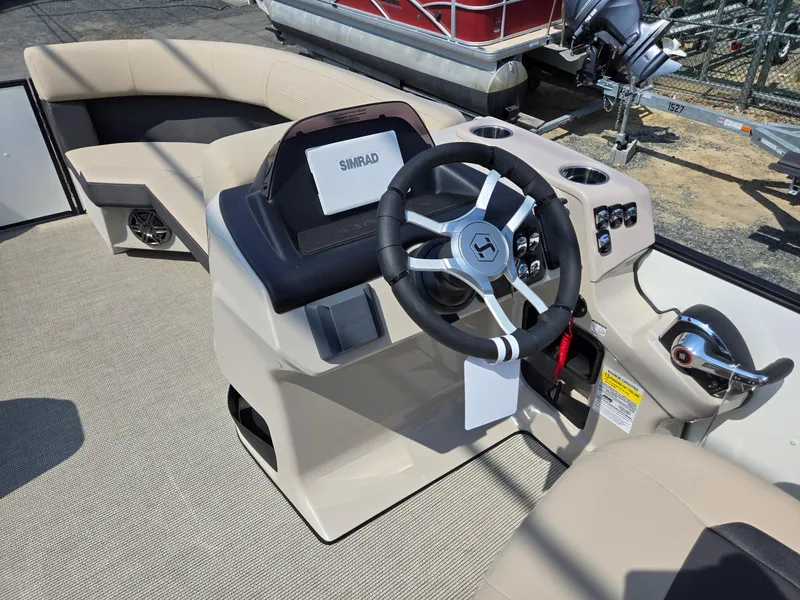 Slide: The Image of 2025 Harris Cruiser 210 boat interior with steering wheel and control panel. - 27