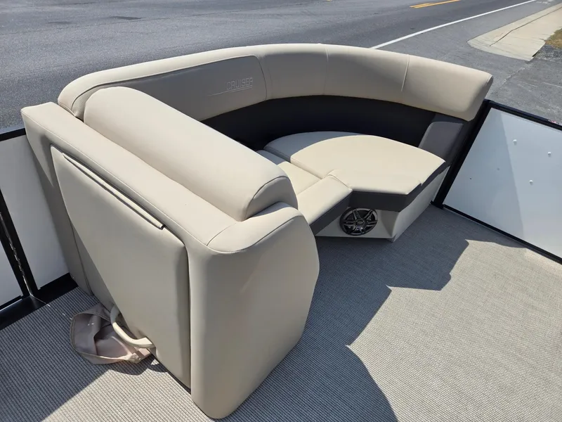 Slide: The Image of 2025 Harris Cruiser 210 boat seating with beige upholstery and speaker. - 29