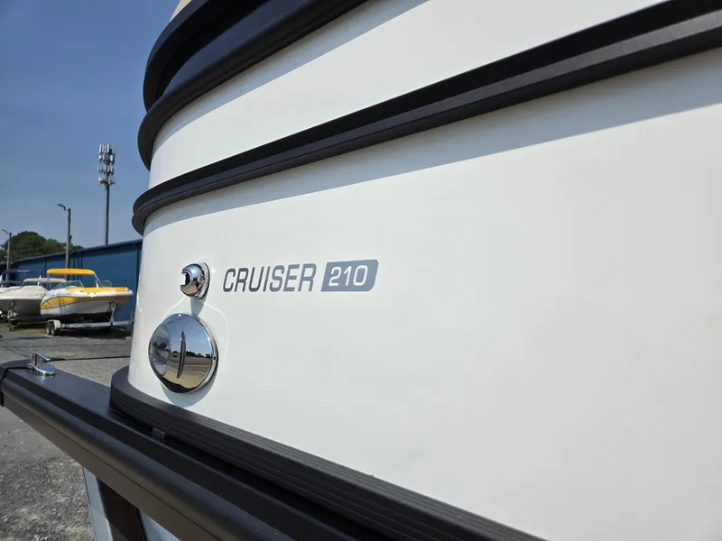 Slide: The Image of 2025 Harris Cruiser 210 boat exterior with logo and chrome detailing. - 31