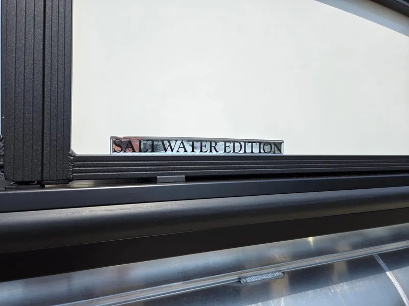 Slide: The Image of 2025 Harris Cruiser 210 Saltwater Edition emblem on boat exterior. - 32