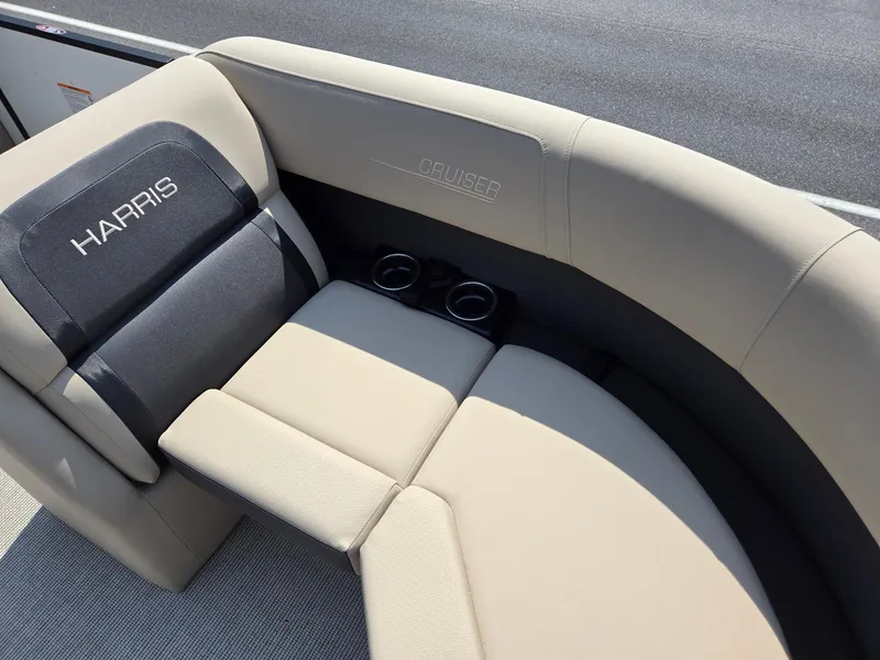 Slide: The Image of 2025 Harris Cruiser 210 boat seating with cup holders, featuring sleek beige and black design. - 8