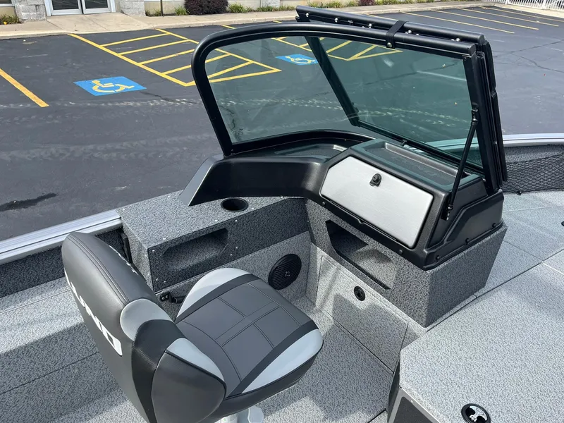 Slide: The Image of 2025 Lund 1775 Impact XS Sport boat interior with seating and console. - 10
