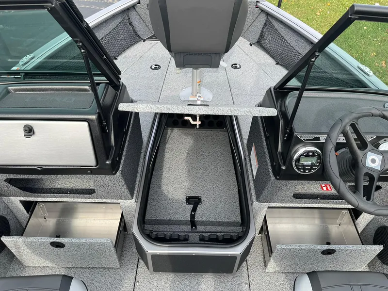Slide: The Image of 2025 Lund 1775 Impact XS Sport boat interior with open storage compartments. - 11