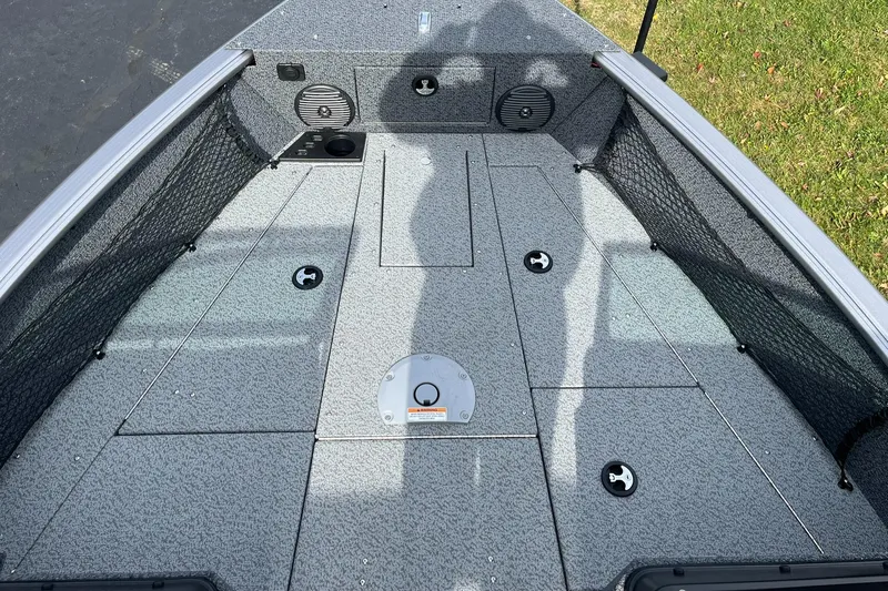 Slide: The Image of 2025 Lund 1775 Impact XS Sport boat deck with storage compartments. - 12