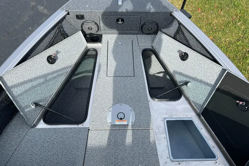 Slide: The Image of 2025 Lund 1775 Impact XS Sport boat interior with open storage compartments. - 13