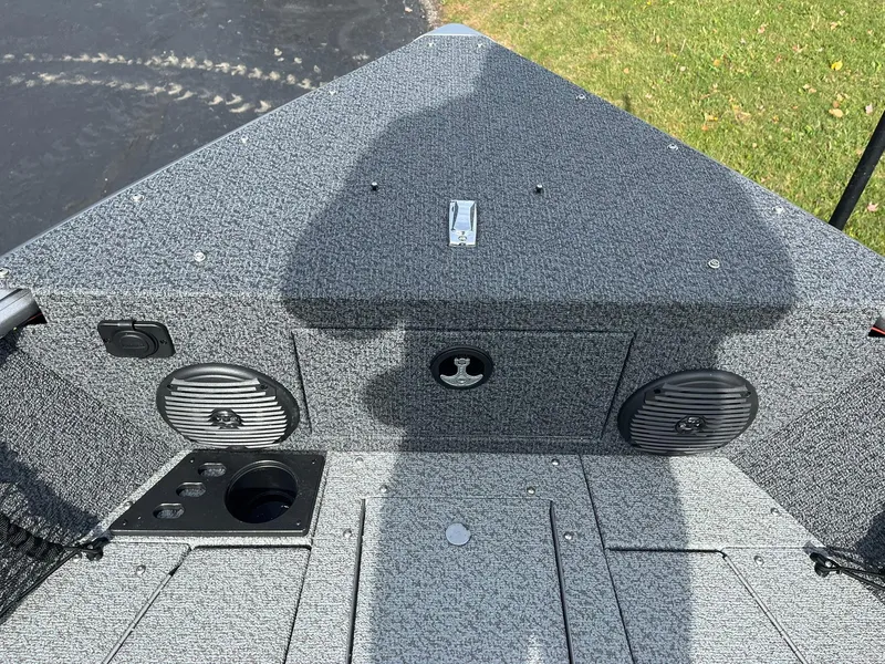 Slide: The Image of 2025 Lund 1775 Impact XS Sport boat interior with speakers and storage compartments. - 14