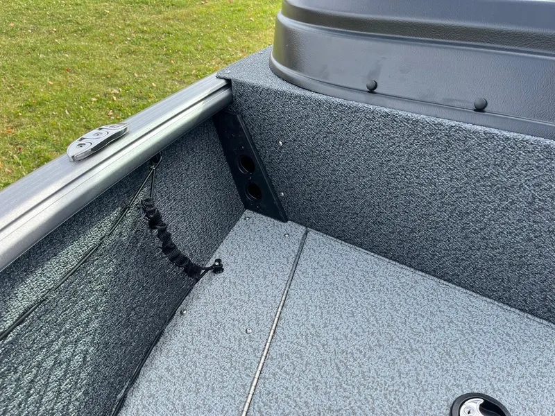 Slide: The Image of 2025 Lund 1775 Impact XS Sport boat interior with gray textured flooring. - 15