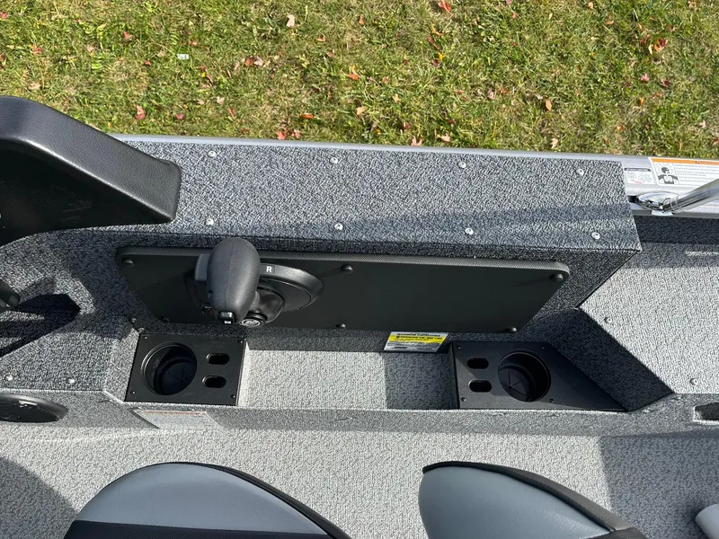 Slide: The Image of 2025 Lund 1775 Impact XS Sport boat interior with cup holders and seating. - 20