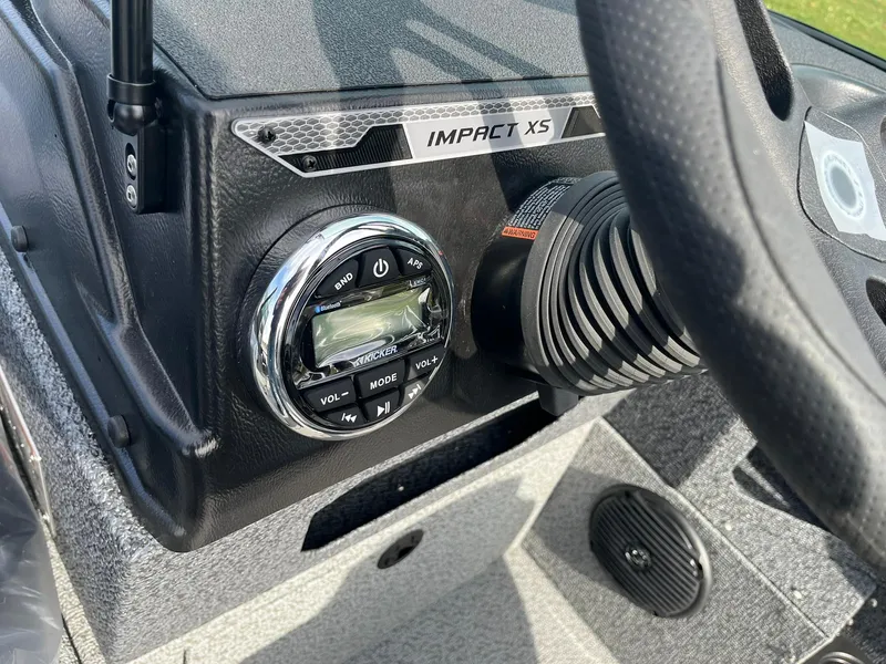 Slide: The Image of 2025 Lund 1775 Impact XS Sport dashboard with control panel and steering wheel. - 21