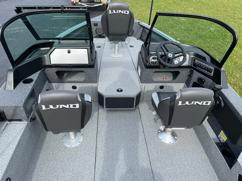 Slide: The Image of 2025 Lund 1775 Impact XS Sport boat interior with seating and steering console. - 5
