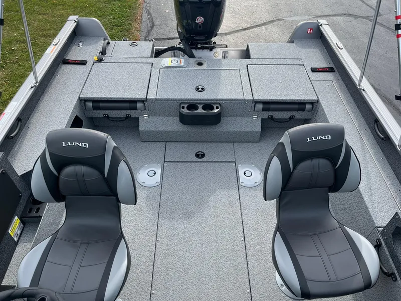 Slide: The Image of 2025 Lund 1775 Impact XS Sport boat interior with two seats and storage compartments. - 6