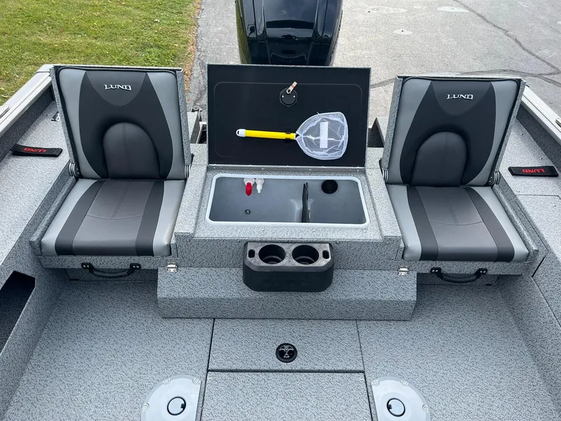 Slide: The Image of 2025 Lund 1775 Impact XS Sport boat interior with seating and storage. - 8