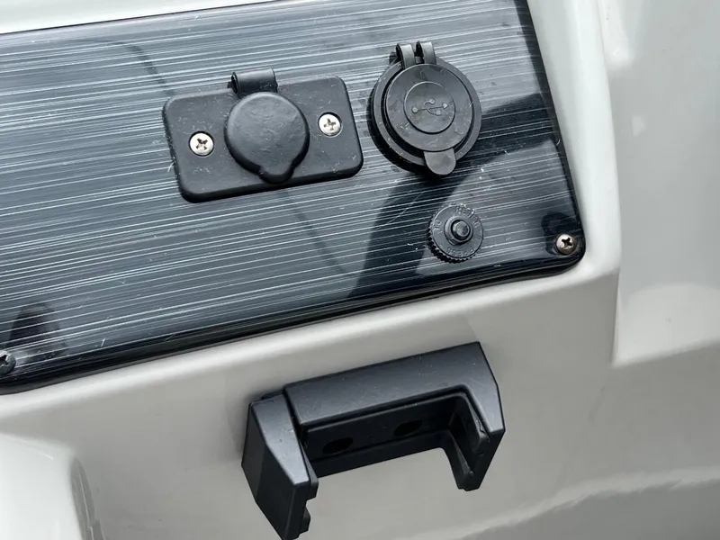 Slide: The Image of Close-up of 2023 Sylvan 8520 Party Fish boat dashboard with power outlets. - 19