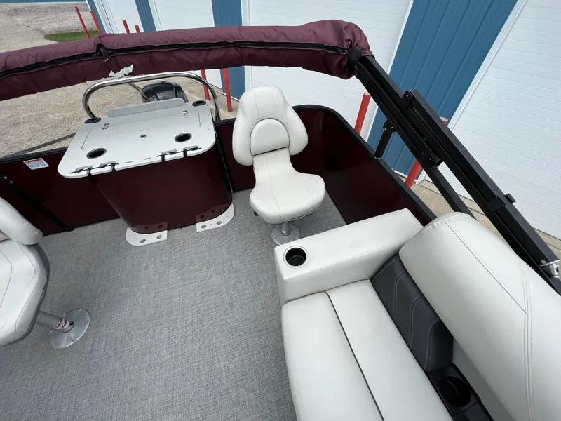 Slide: The Image of 2023 Sylvan 8520 Party Fish boat interior with seating and helm. - 21