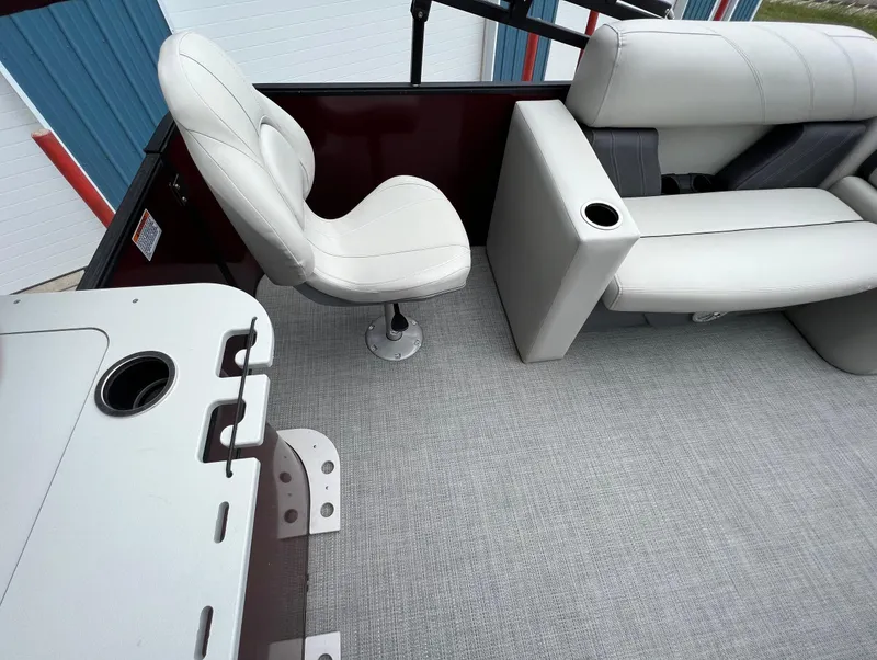 Slide: The Image of 2023 Sylvan 8520 Party Fish boat interior with white seating and gray flooring. - 26