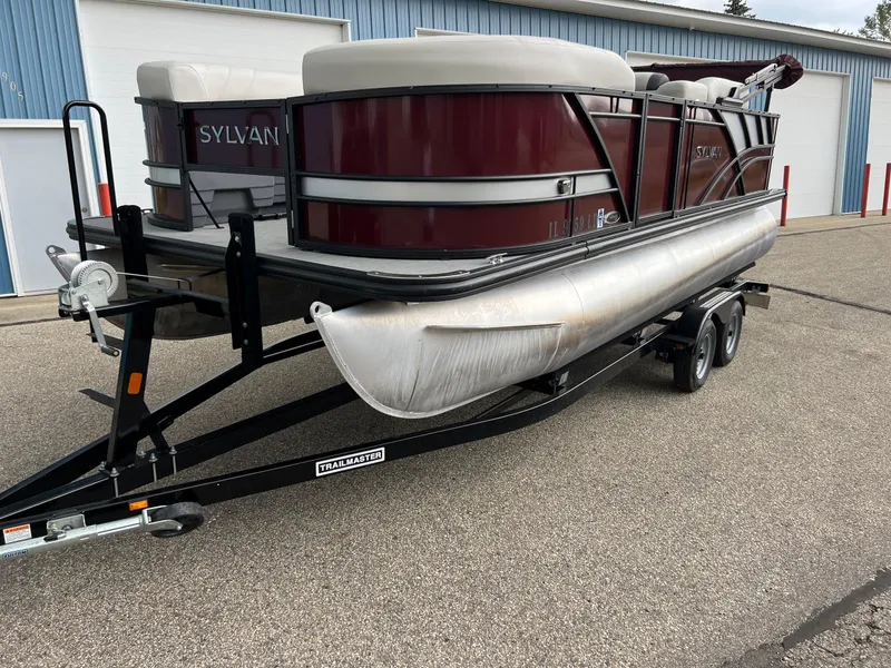 Slide: The Image of 2023 Sylvan 8520 Party Fish pontoon boat on trailer, parked outdoors. - 28