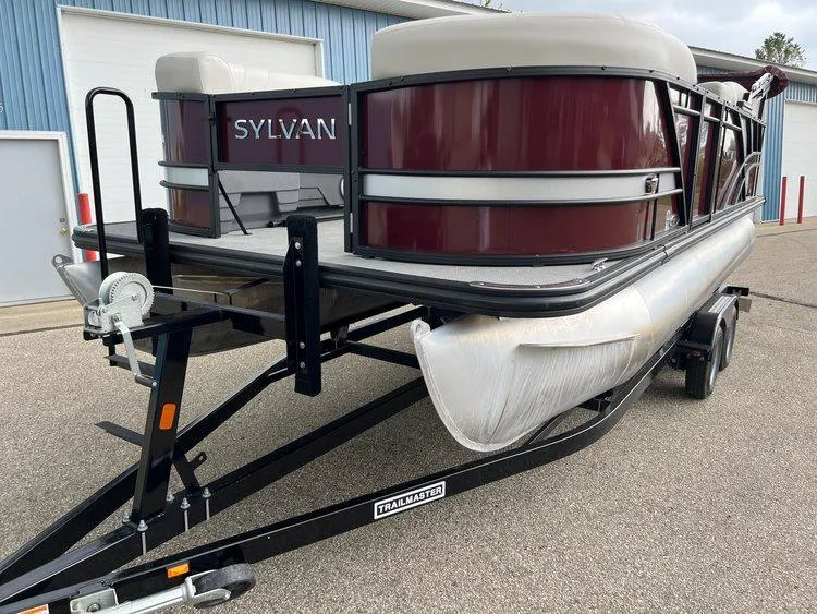 Slide: The Image of 2023 Sylvan 8520 Party Fish pontoon boat on trailer, maroon and silver design. - 29
