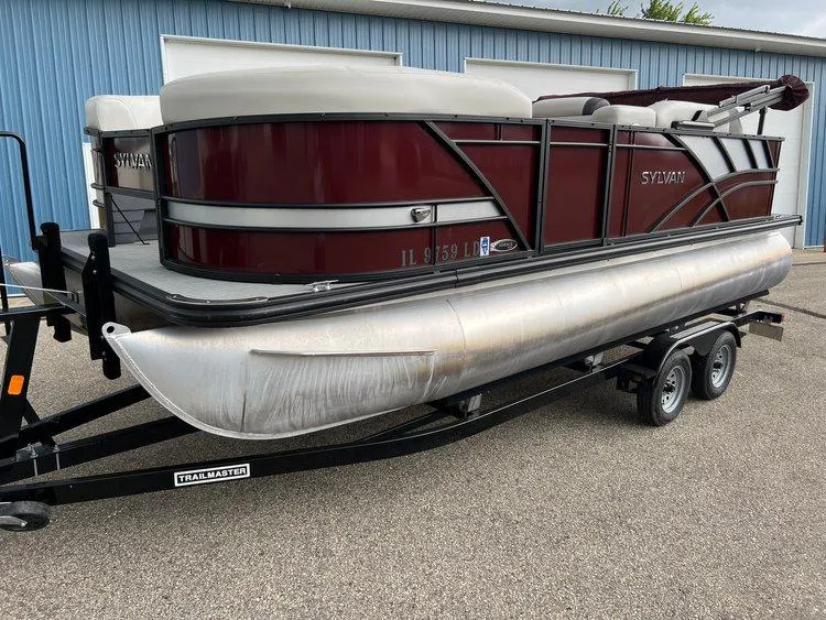 Slide: The Image of 2023 Sylvan 8520 Party Fish pontoon boat on trailer, parked outdoors. - 30