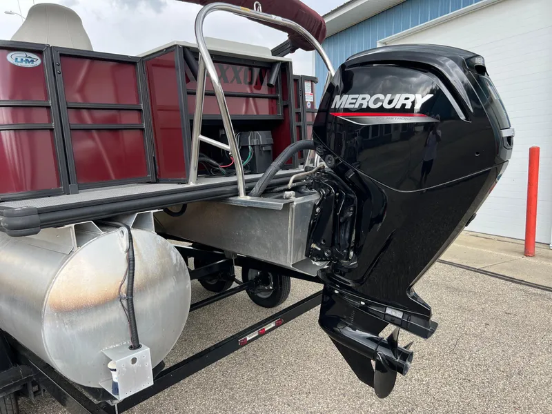 Slide: The Image of 2023 Sylvan 8520 Party Fish with Mercury outboard motor, docked on a trailer. - 31