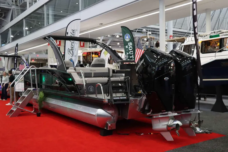 Slide: The Image of 2025 Barletta LUSSO 25UCAT pontoon boat displayed indoors on red carpet. - 1