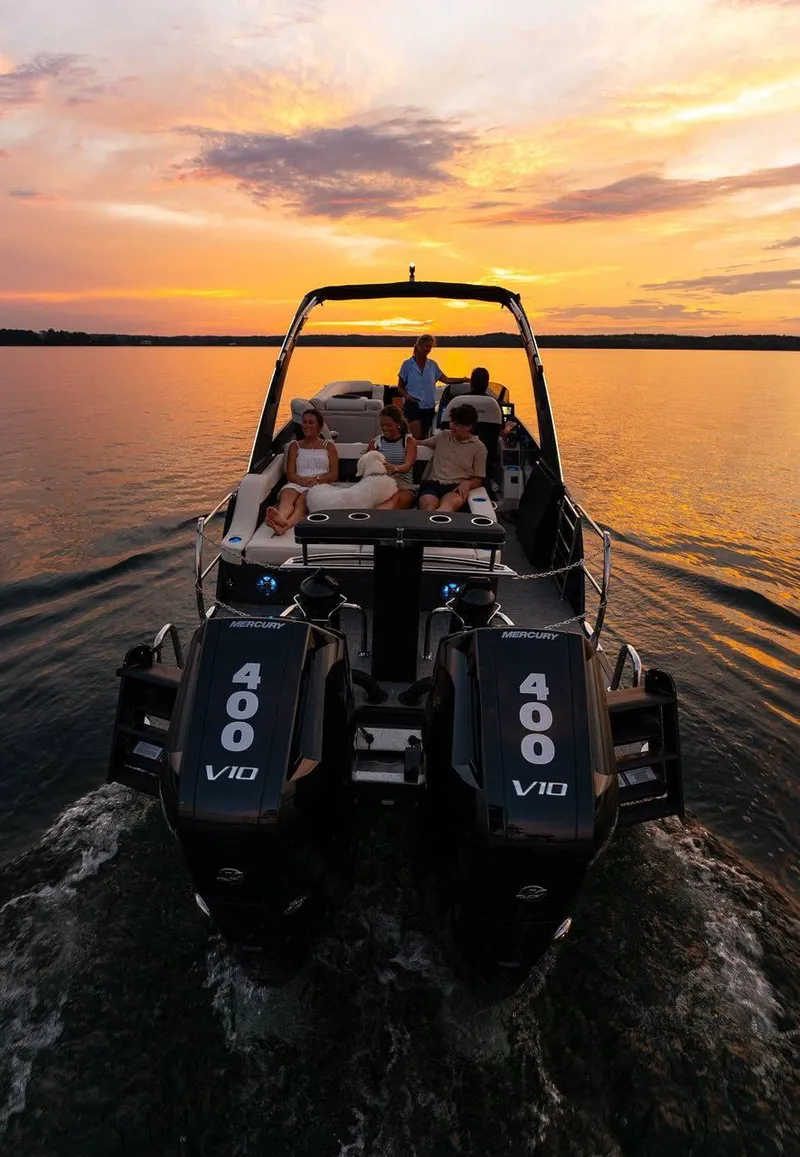 Slide: The Image of 2025 Barletta LUSSO 25UCAT boat cruising at sunset with passengers relaxing. - 11