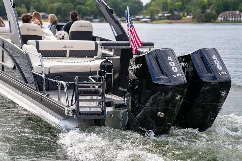 Slide: The Image of 2025 Barletta LUSSO 25UCAT pontoon boat with dual Mercury 400 V10 engines on a lake. - 12