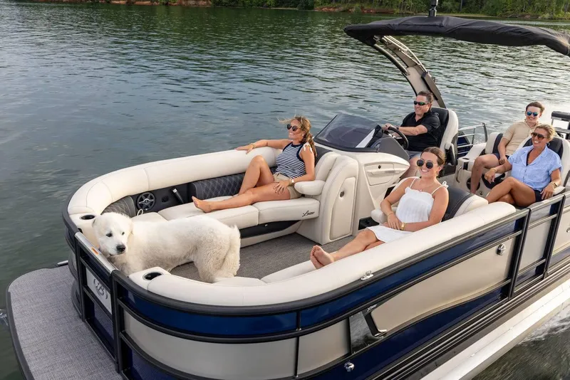 Slide: The Image of 2025 Barletta LUSSO 25UCAT pontoon boat with passengers and a dog on a lake. - 14