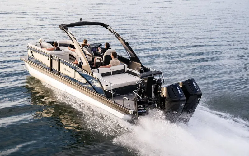 Slide: The Image of 2025 Barletta LUSSO 25UCAT luxury pontoon boat cruising on water. - 2