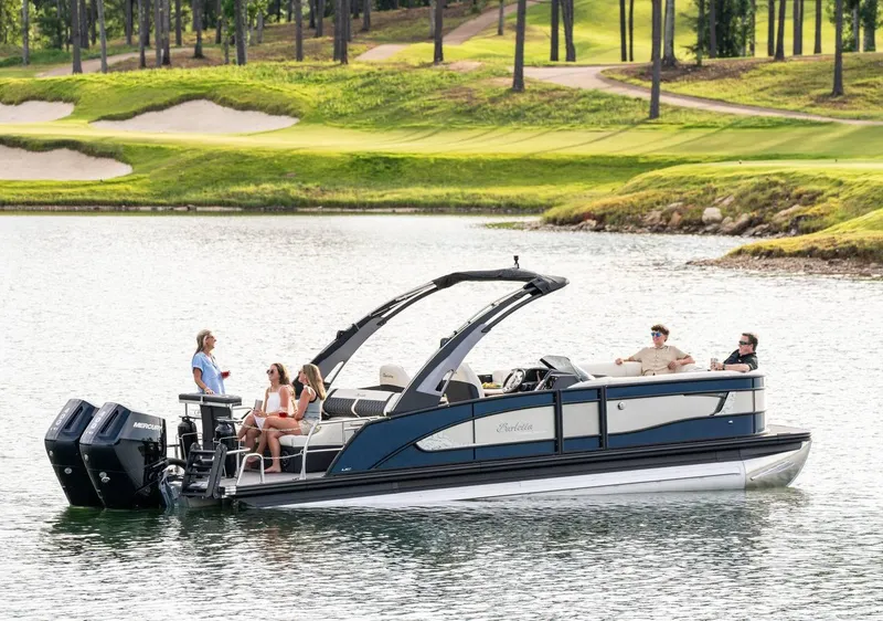 Slide: The Image of 2025 Barletta LUSSO 25UCAT pontoon boat cruising on a scenic lake. - 3