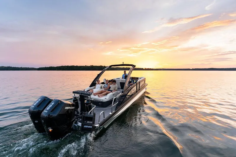 Slide: The Image of 2025 Barletta LUSSO 25UCAT pontoon boat cruising at sunset on a serene lake. - 4