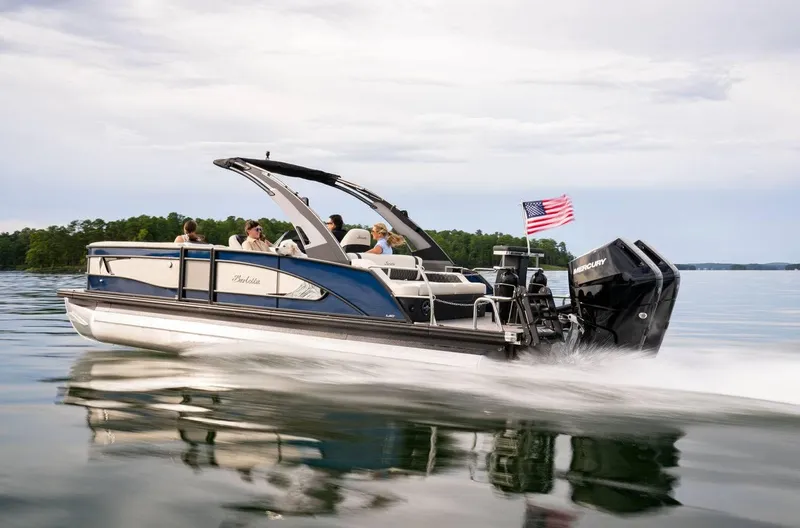Slide: The Image of 2025 Barletta LUSSO 25UCAT pontoon boat cruising on a serene lake. - 5