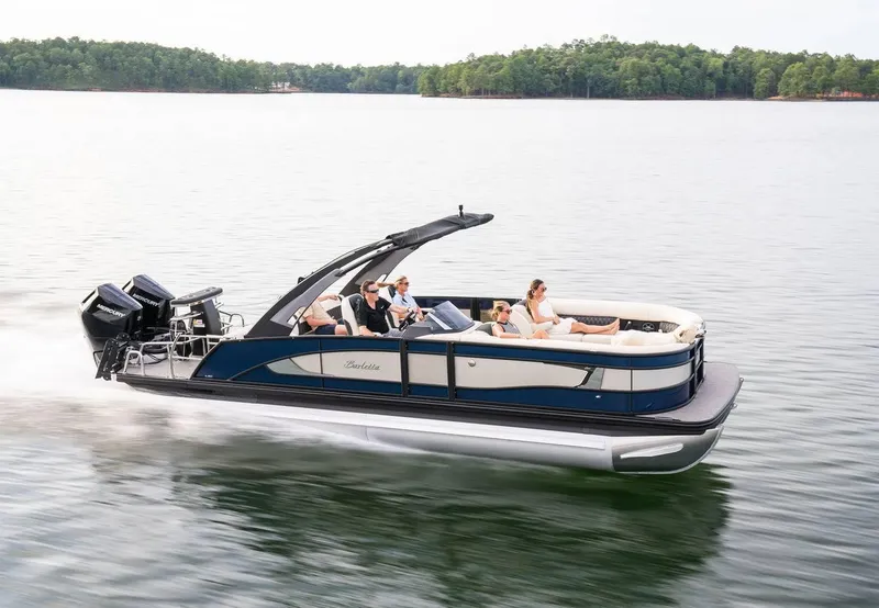 Slide: The Image of 2025 Barletta LUSSO 25UCAT pontoon boat cruising on a serene lake. - 6
